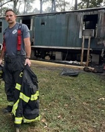 Tom Houpt in firefighter turnout gear at a fire scene